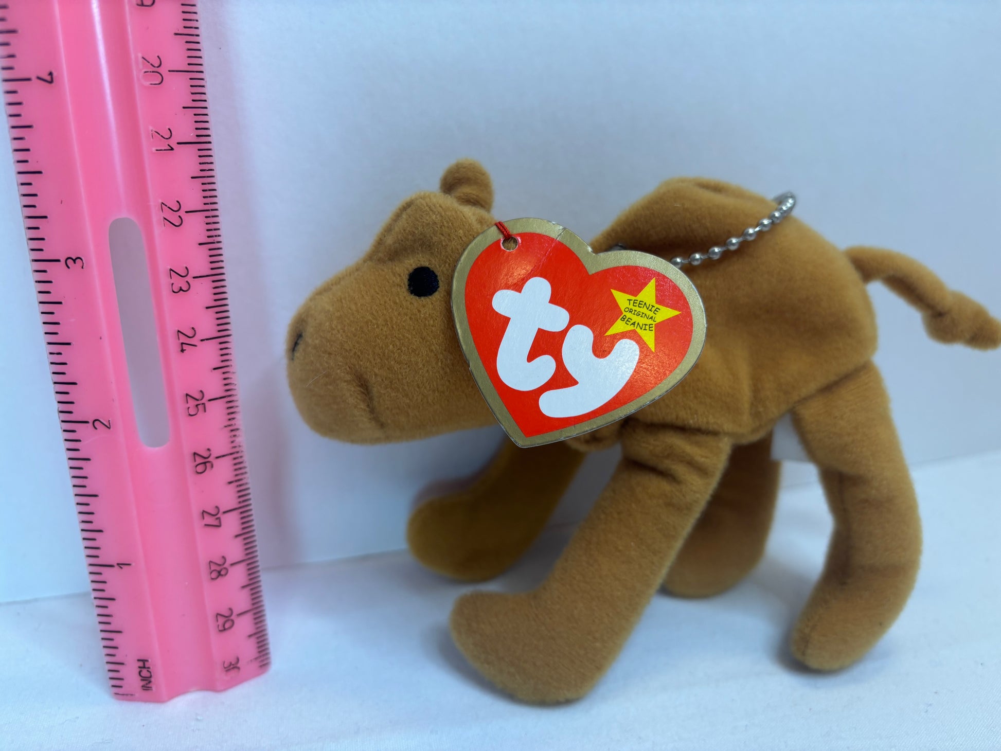 Brown plush camel bag charm with a Ty tag on a white background