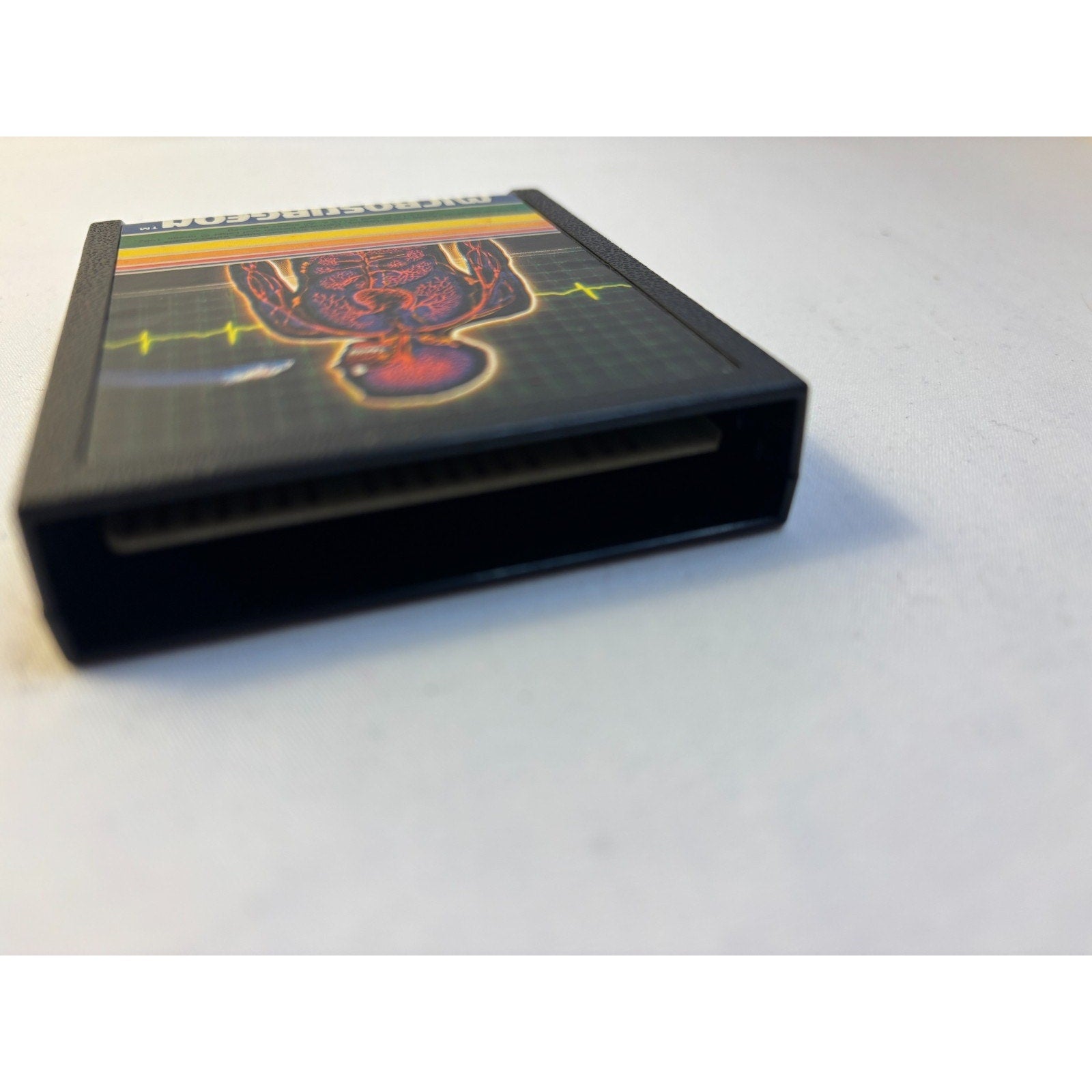 intellivision microsurgeon cartridge with colorful graphics on a white surface
