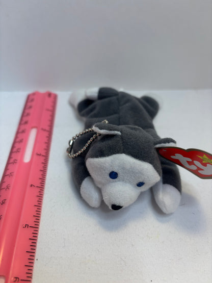 Gray and white dog plush bag charm with a red tag on a white background