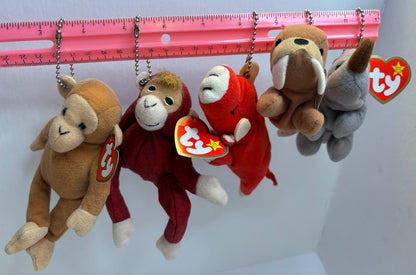 assorted colorful beanie baby plush toy bag charms on a white background