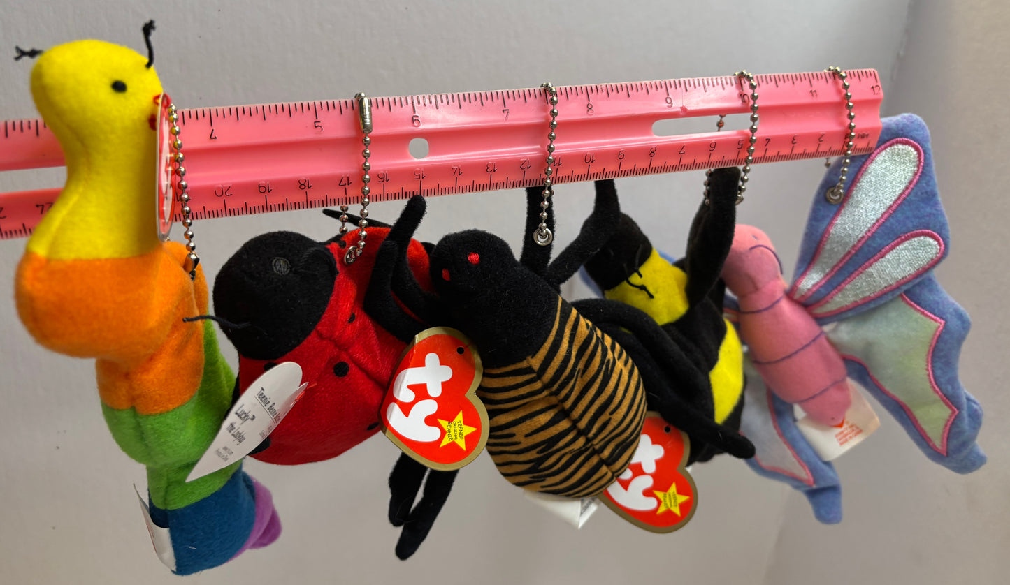 assorted colorful beanie baby plush toy bag charms on a white background