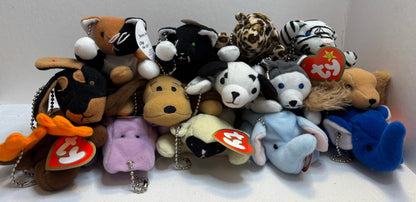 assorted colorful beanie baby plush toy bag charms in a pile on a white background