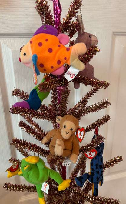 Decorative tree with TY plush bag charms including a fish, monkey, and others on a white background.