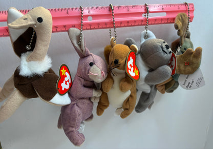 assorted colorful beanie baby plush toy bag charms on a white background